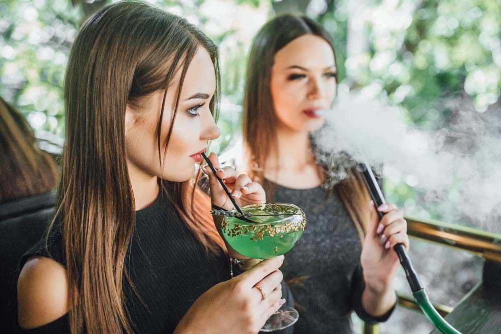 Cannabis Drinks. Ladies drinking cannabis juice.